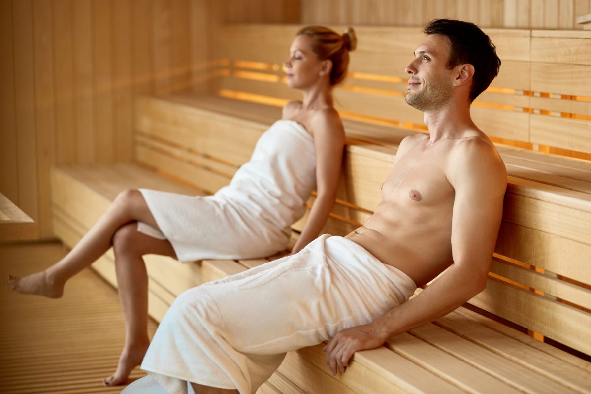 serene couple relaxing sauna while spending their weekend health spa focus is man (1) (1)